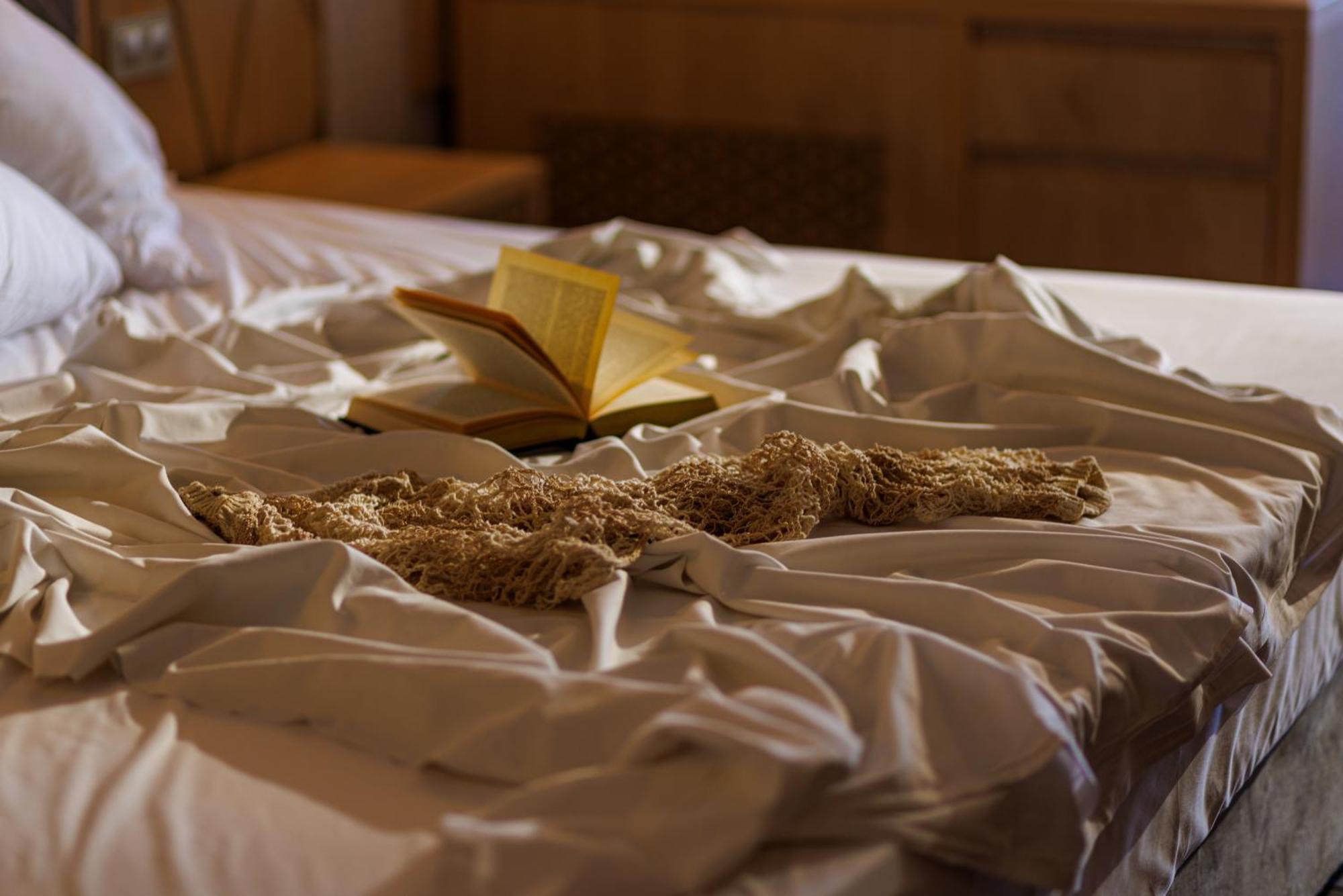 Secrets Sunny Beach Resort & Spa (Adults Only) Bagian luar foto A bed with a book and a cat